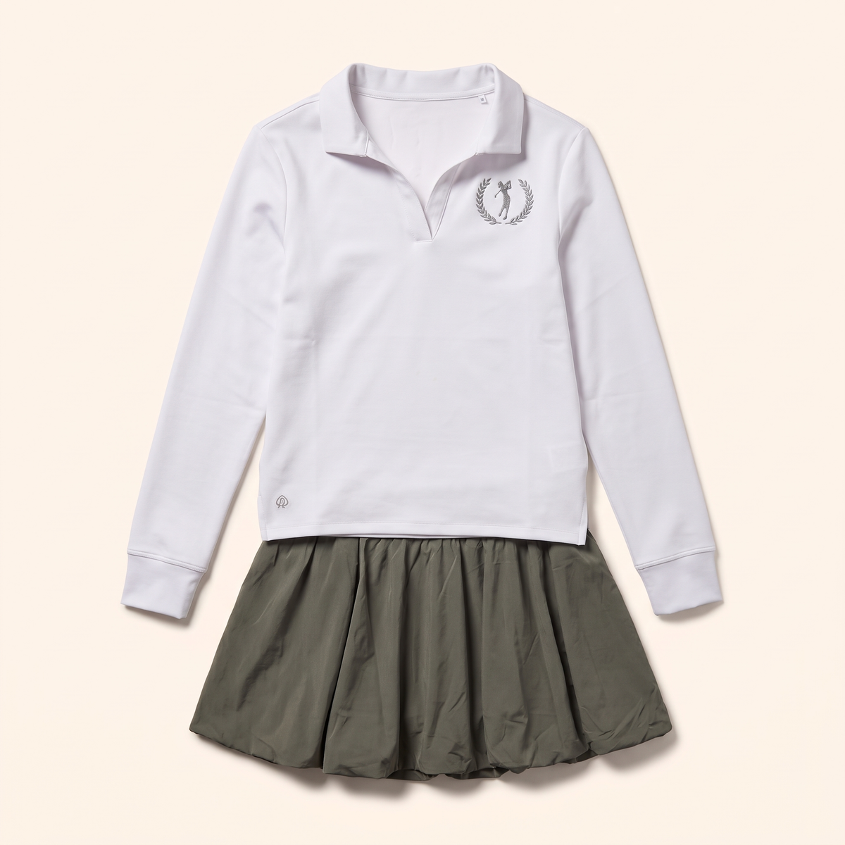 Olive bubble skirt styled with the long sleeve crest polo