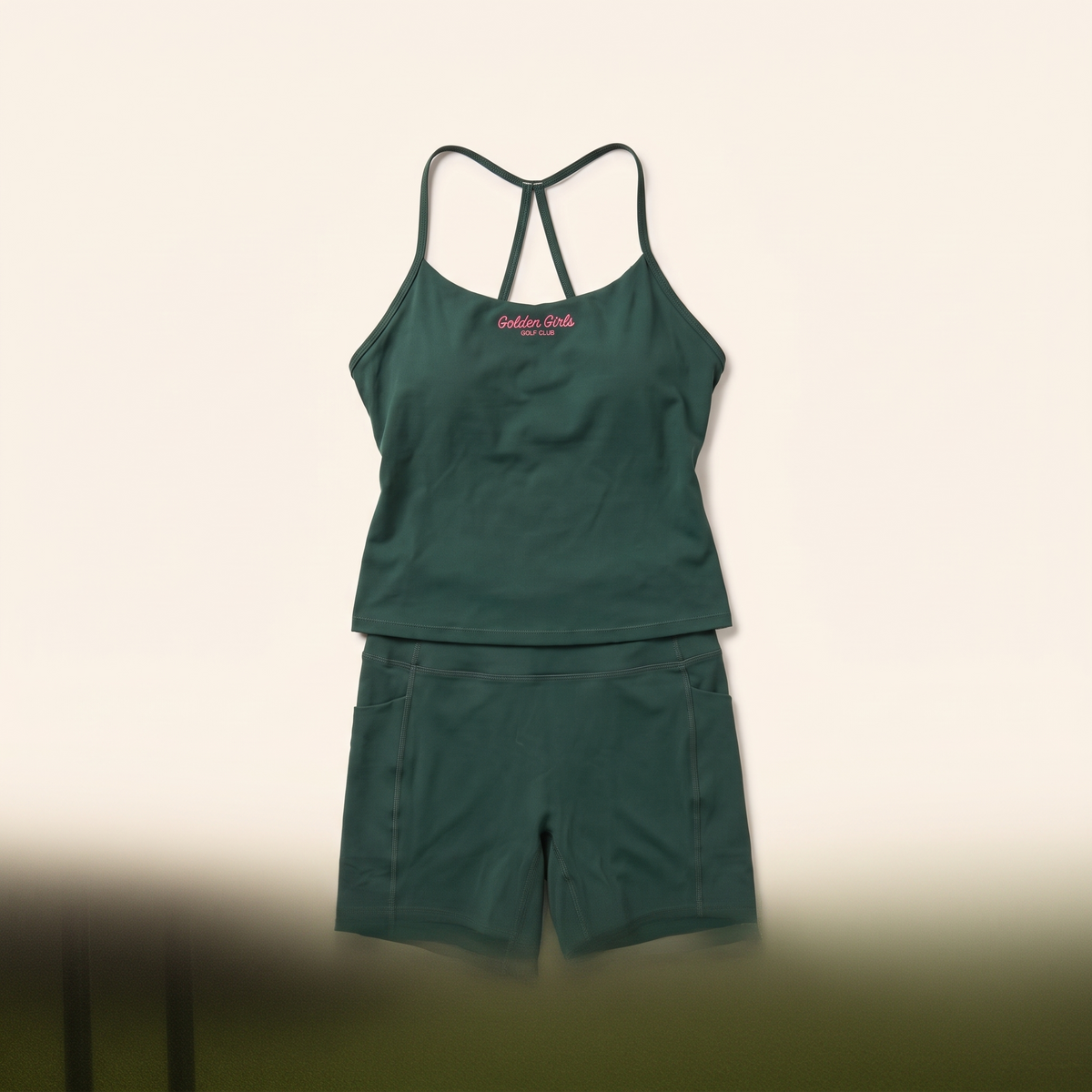 Green bike shorts styled with the script cami
